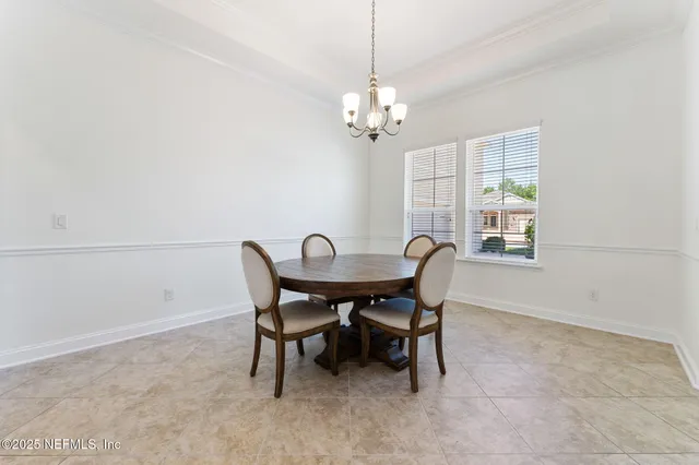 a kitchen with granite countertop white cabinets and stainless steel appliances