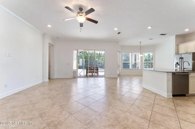 a kitchen with granite countertop white cabinets and appliances