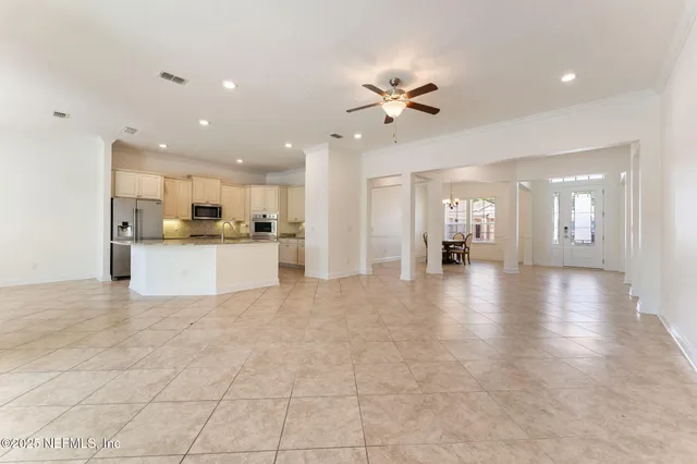 a kitchen with white cabinets and stainless steel appliances