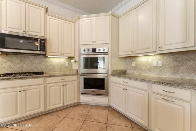 a bathroom with a granite countertop sink a toilet and a shower