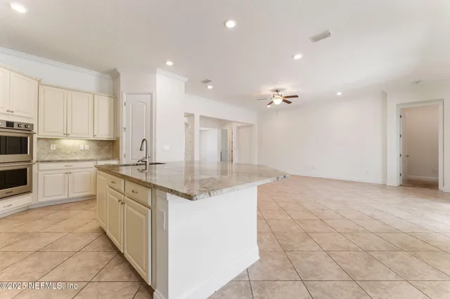 a spacious bathroom with a granite countertop sink mirror and