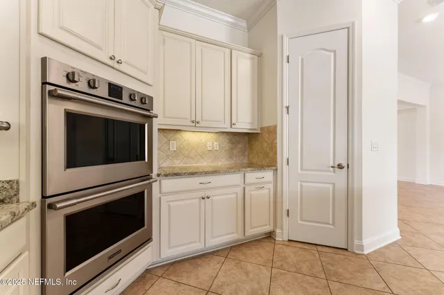 a bathroom with a granite countertop bathtub shower sink vanity mirror and toilet