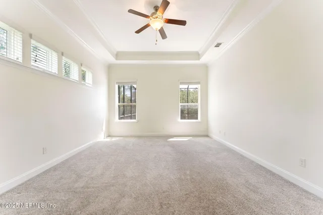 a bathroom with a granite countertop sink mirror vanity and toilet