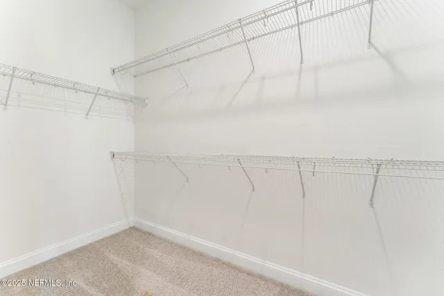 a bedroom with a bed and a potted plant