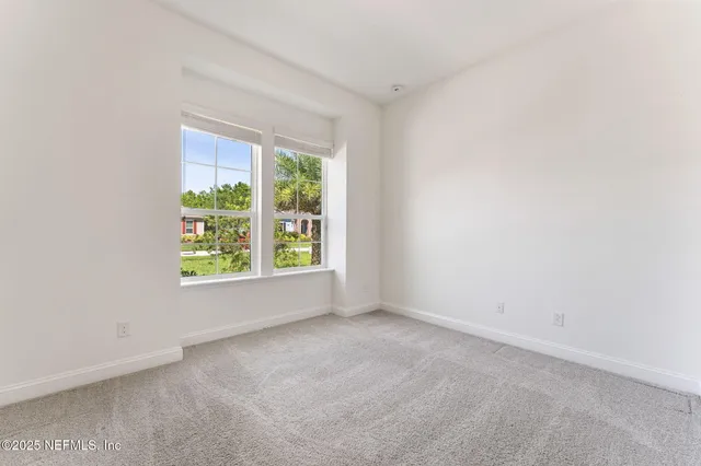 a view of a balcony with a floor to ceiling window and wooden floor
