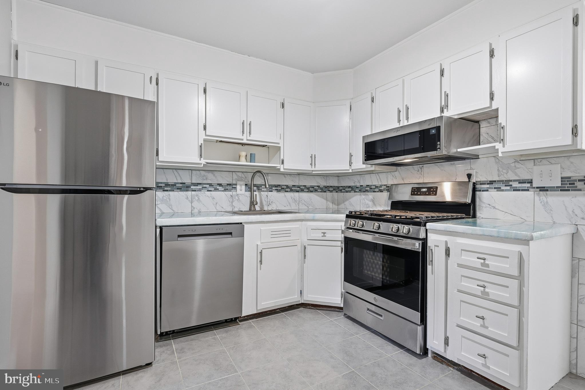 7365 Race Road Hanover, MD 21076 - Photo 15 of 68 a kitchen with cabinets stainless steel appliances and a counter space