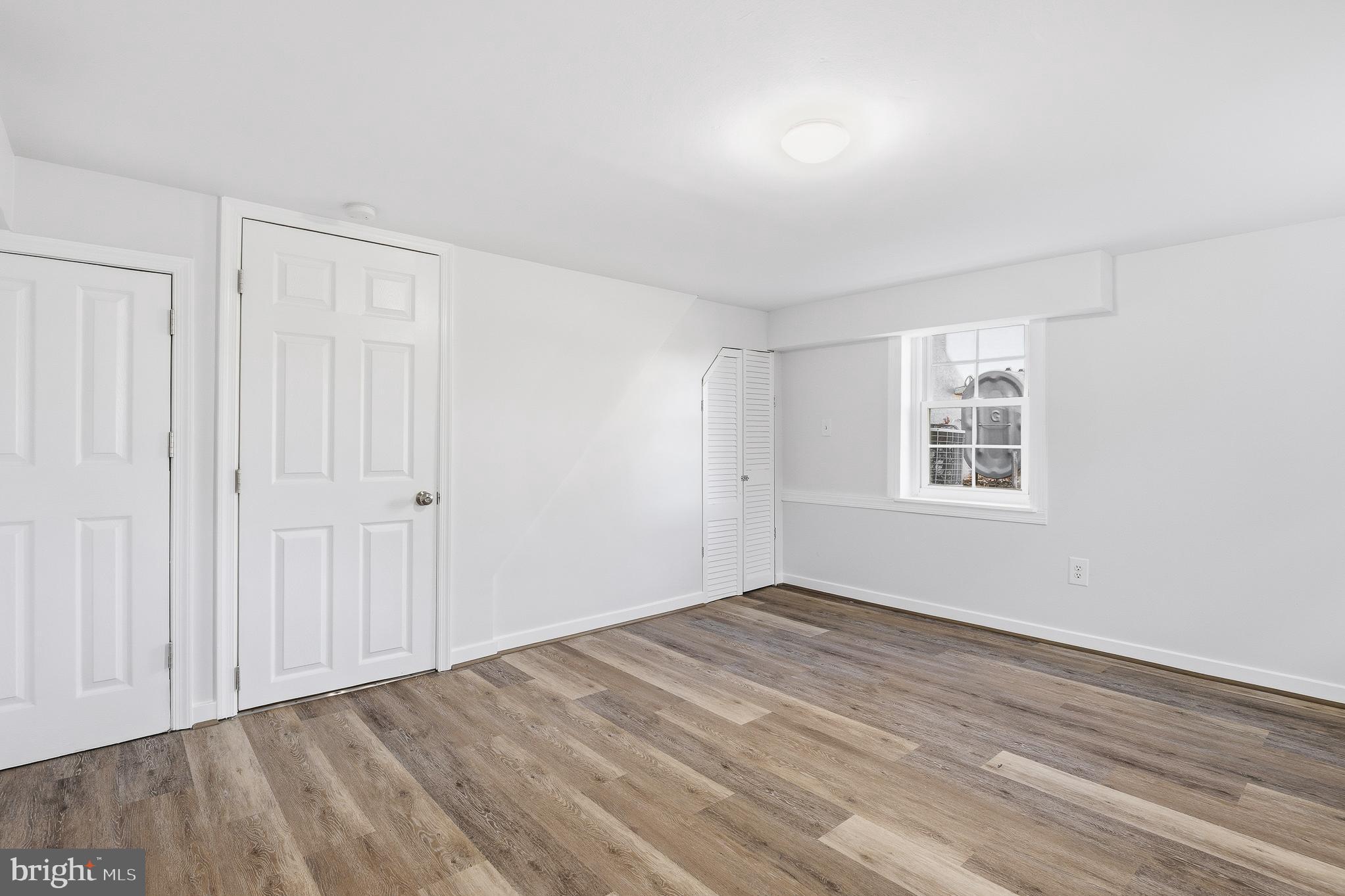 7365 Race Road Hanover, MD 21076 - Photo 18 of 68 an empty room with wooden floor and windows