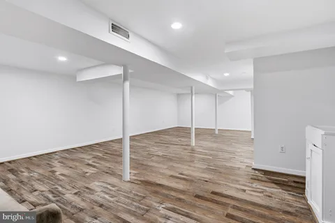 a bathroom with a toilet a sink a vanity and mirror