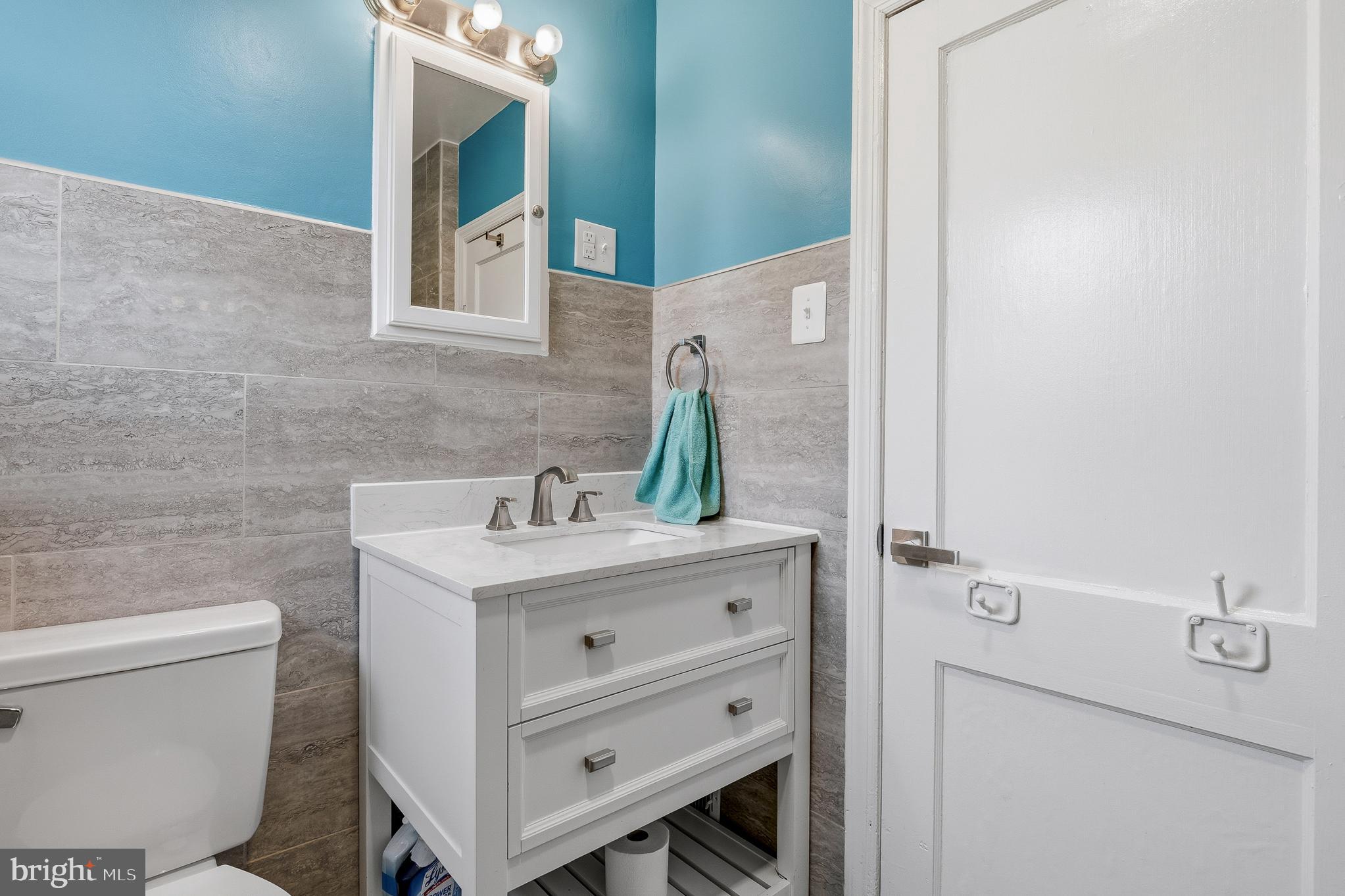 7365 Race Road Hanover, MD 21076 - Photo 36 of 68 a bathroom with a sink a toilet and mirror