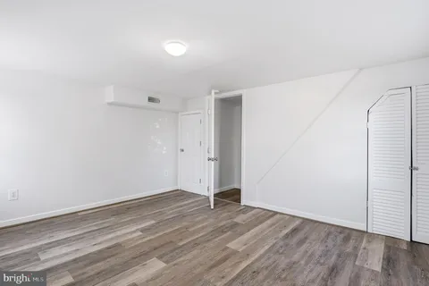 an empty room with wooden floor