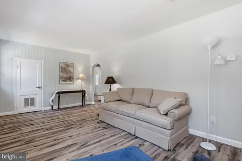 a bedroom with a bed and a window with chair