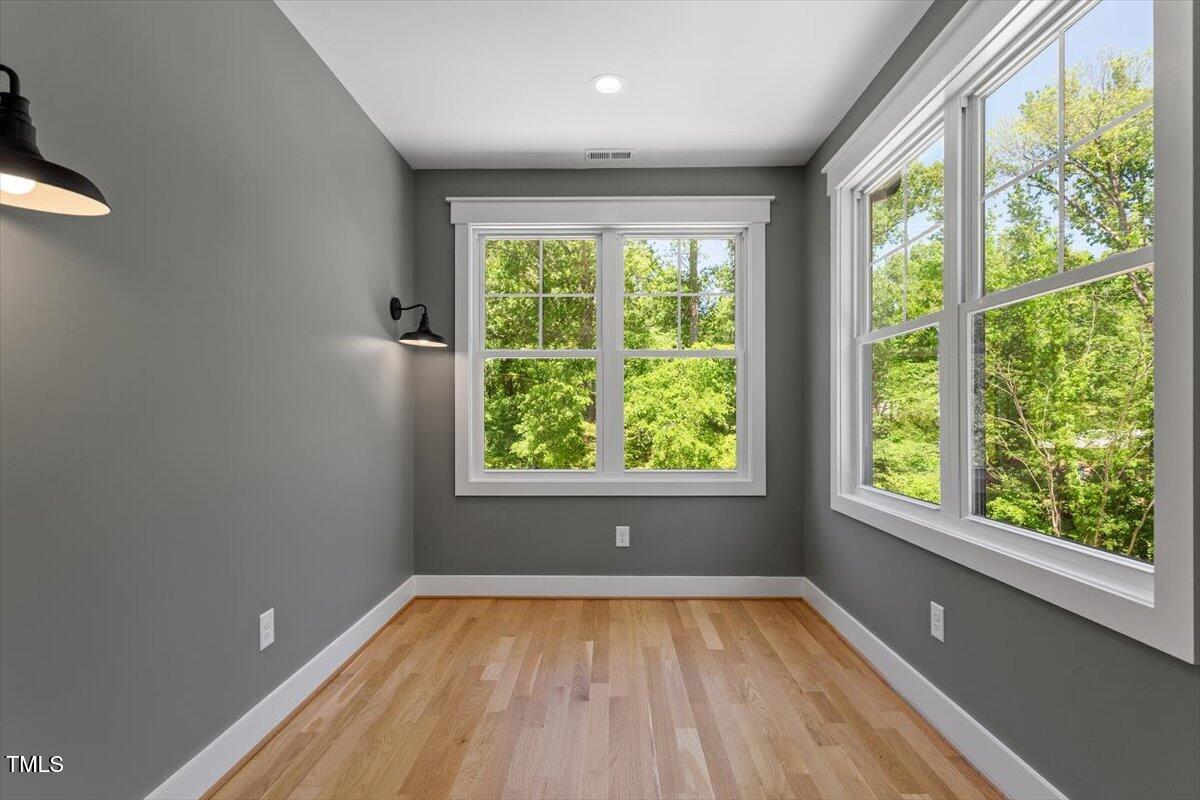 3934 Old Chapel Hill Road Durham, NC 27707 - Photo 29 of 47 a view of empty room with wooden floor and fan