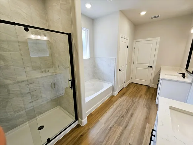 a bathroom with a double vanity sink and mirror