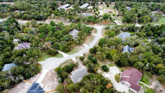 an aerial view of a house with a yard and lake view