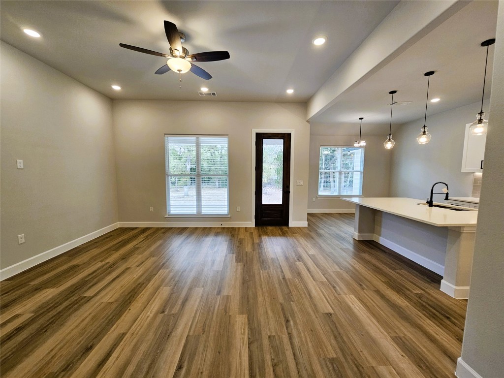 116 Pine Point Cove Elgin, TX 78621 - Photo 3 of 31 a view of a room with wooden floor and a ceiling fan