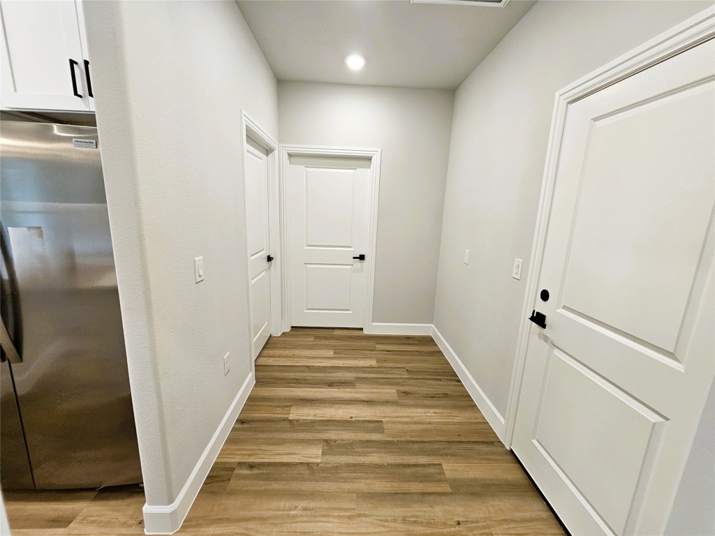 116 Pine Point Cove Elgin, TX 78621 - Photo 6 of 31 a view of a hallway with wooden floor and staircase