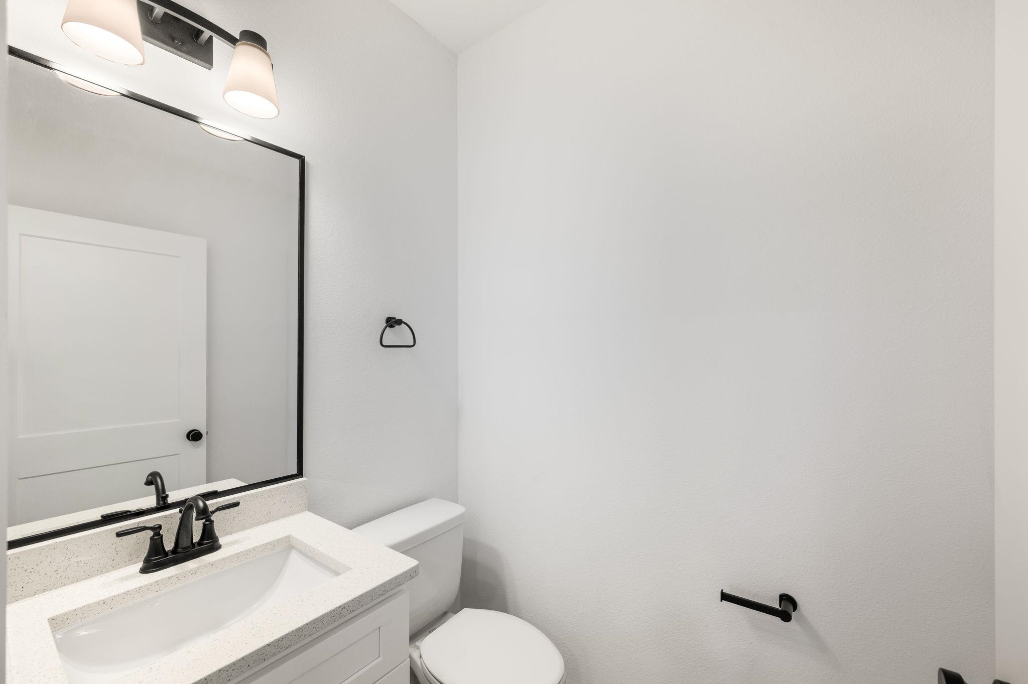 863 West 12th Street St. Augustine, FL 32084 - Photo 19 of 41 a bathroom with a sink toilet and mirror