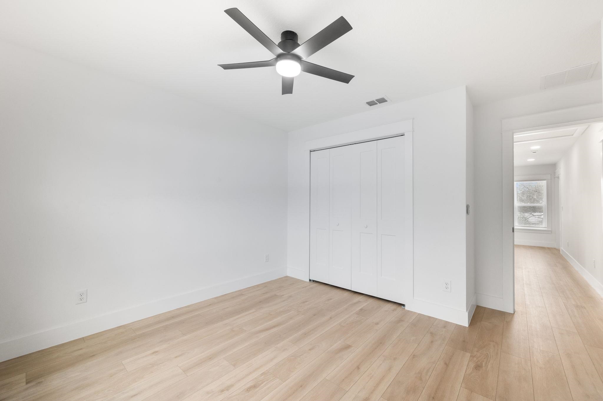 863 West 12th Street St. Augustine, FL 32084 - Photo 41 of 41 an empty room with wooden floor and a ceiling fan