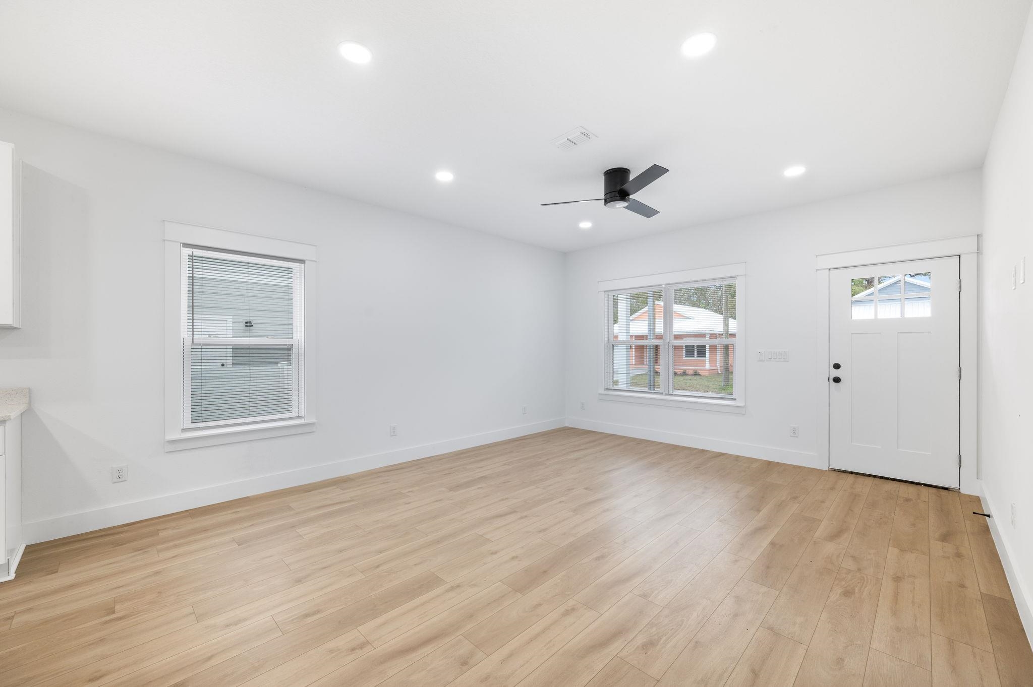 863 West 12th Street St. Augustine, FL 32084 - Photo 8 of 41 an empty room with wooden floor and windows