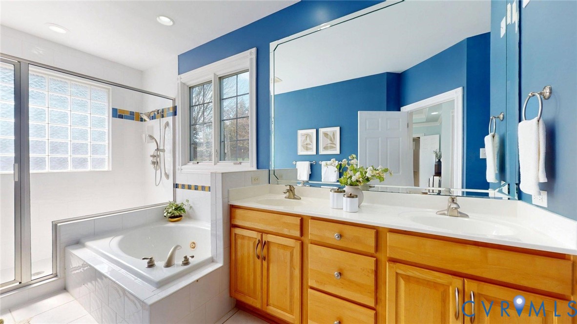 9012 Amberhill Loop North Chesterfield, VA 23236 - Photo 17 of 30 a bathroom with a tub sink and mirror