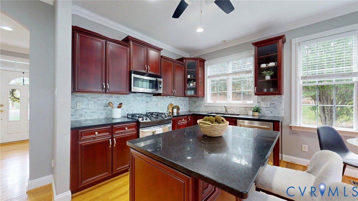 9012 Amberhill Loop North Chesterfield, VA 23236 - Photo 7 of 30 a kitchen with stainless steel appliances granite countertop a sink a stove and cabinets