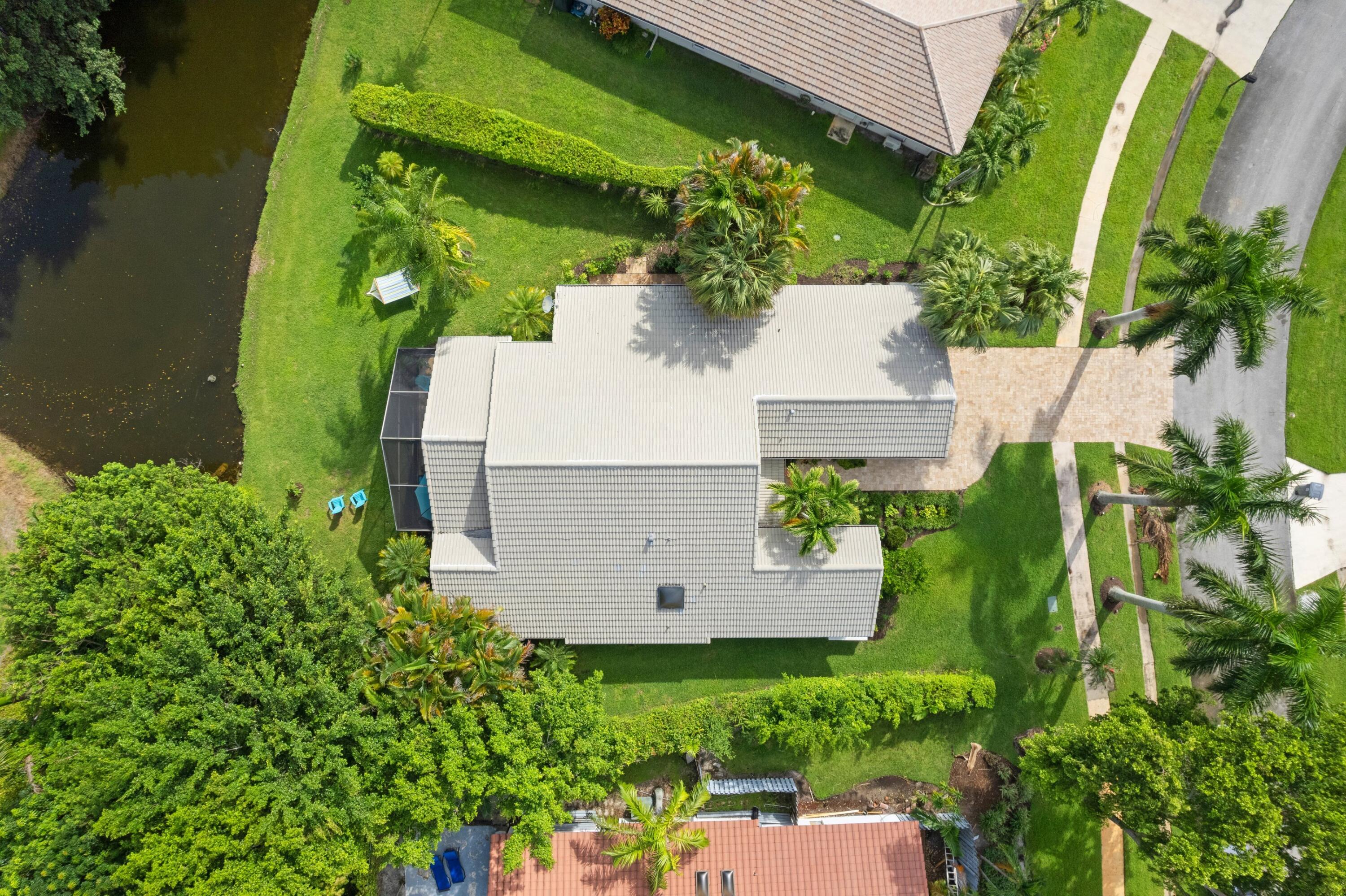 10238 Crosswind Road Boca Raton, FL 33498 - Photo 1 of 42 an aerial view of a house with a yard
