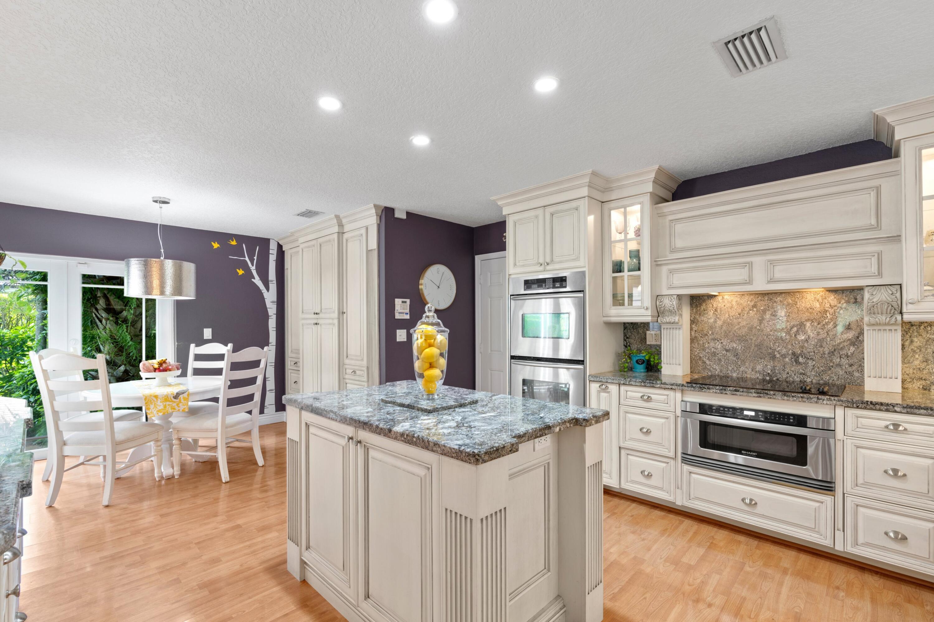 10238 Crosswind Road Boca Raton, FL 33498 - Photo 11 of 42 a kitchen with stainless steel appliances granite countertop a stove and a sink