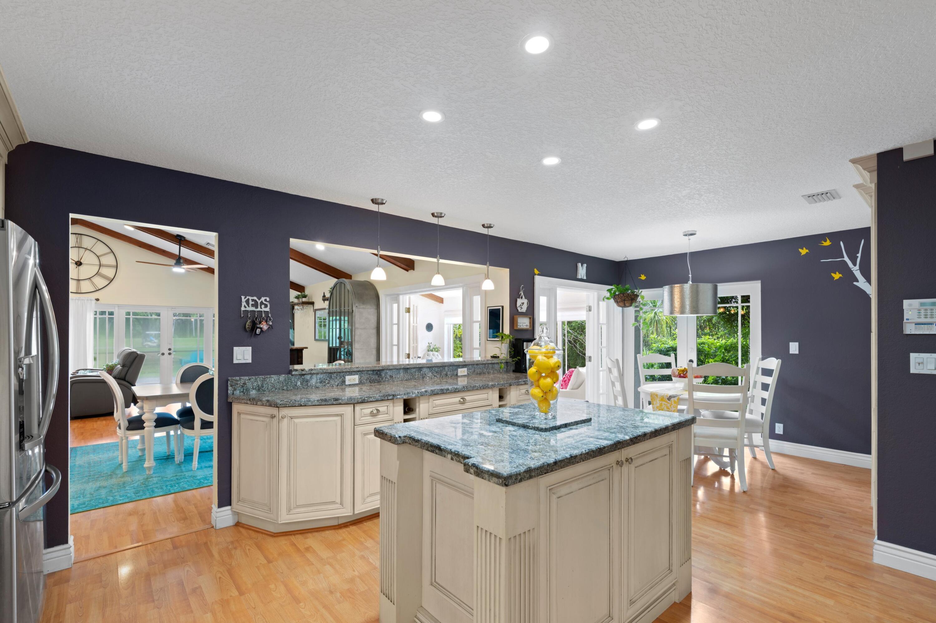 10238 Crosswind Road Boca Raton, FL 33498 - Photo 14 of 42 a kitchen with granite countertop sink and cabinets