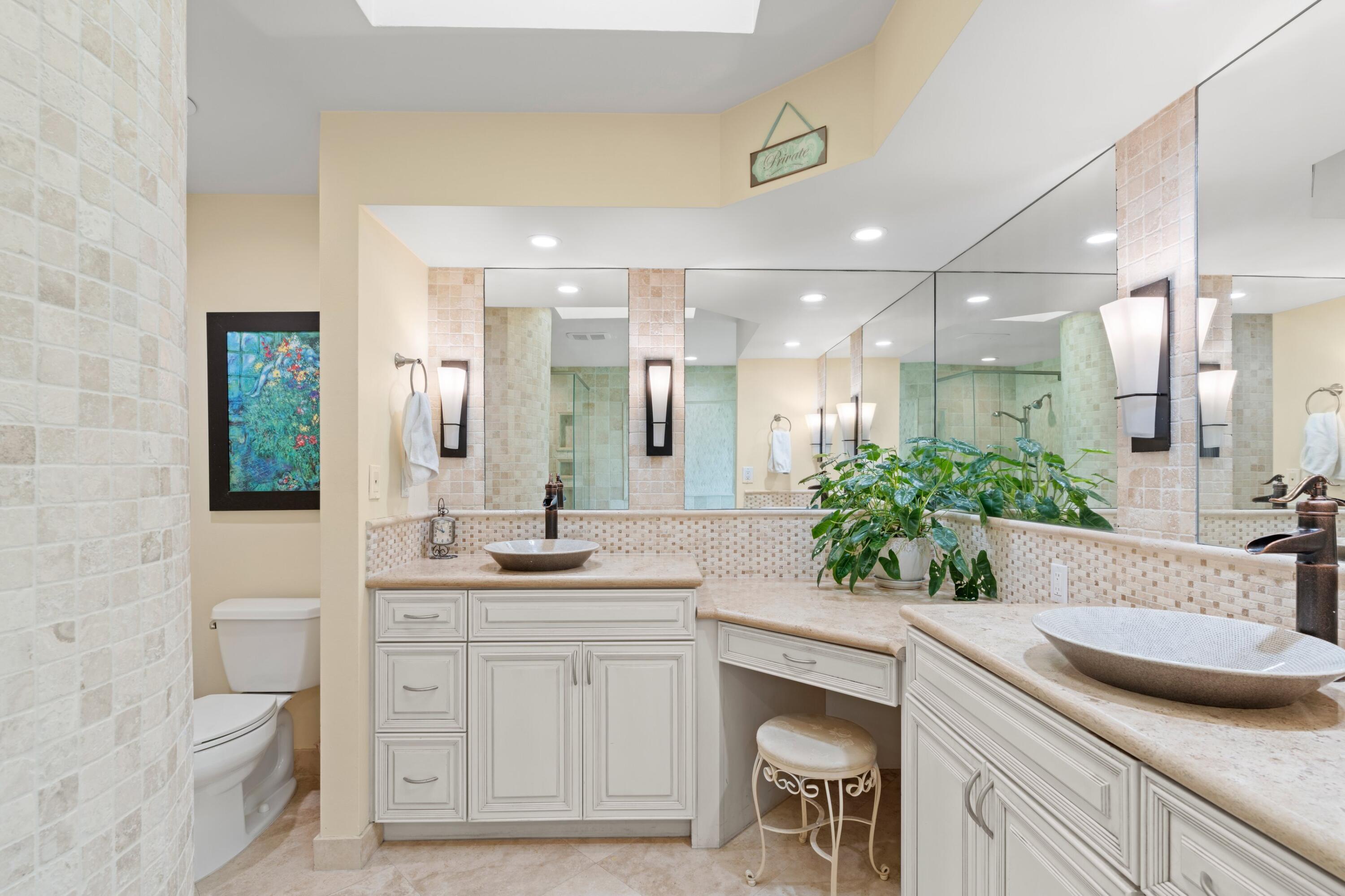 10238 Crosswind Road Boca Raton, FL 33498 - Photo 17 of 42 a bathroom with a granite countertop sink mirror and toilet