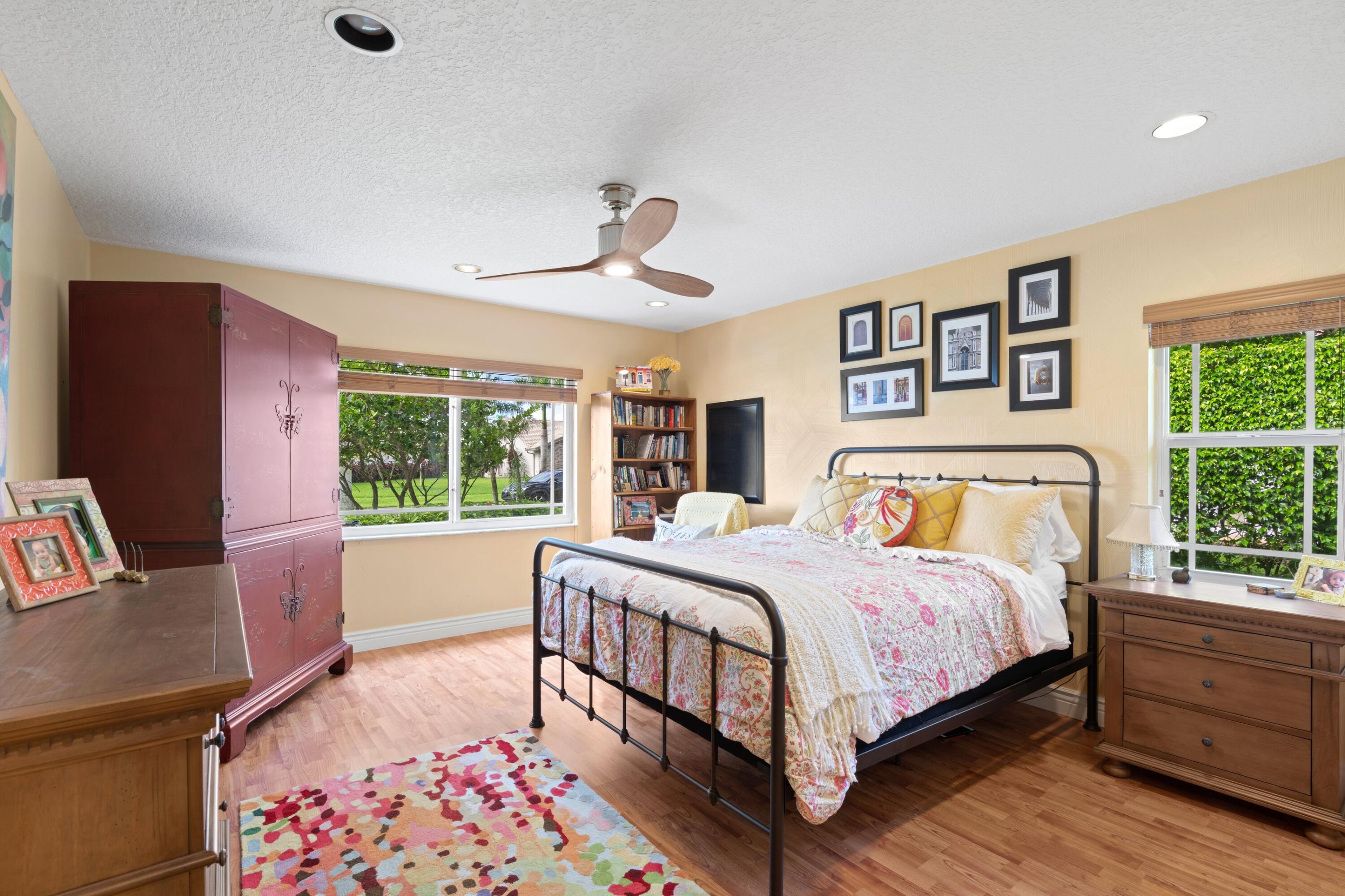 10238 Crosswind Road Boca Raton, FL 33498 - Photo 20 of 42 a bedroom with a large bed and a couch