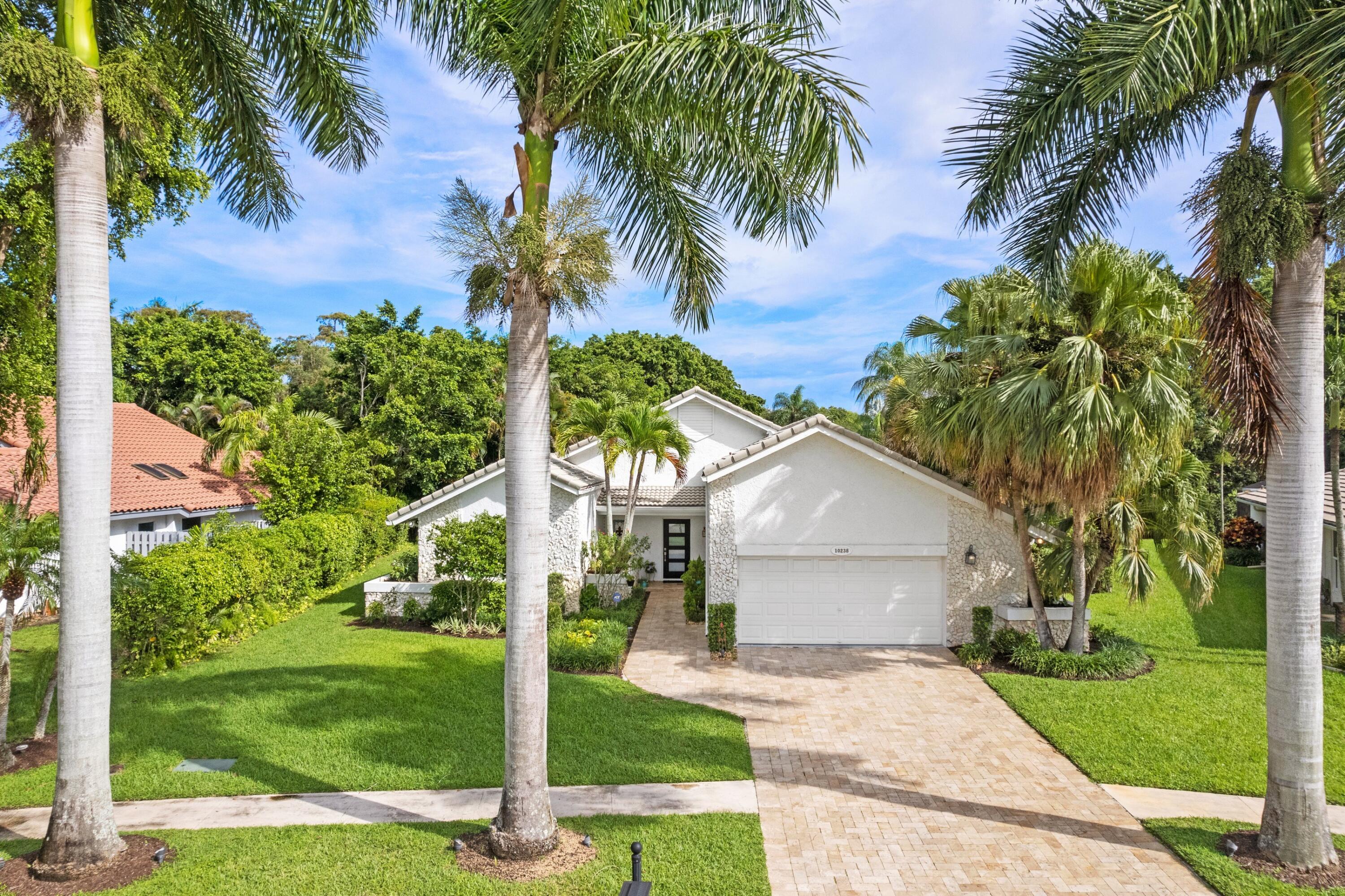 10238 Crosswind Road Boca Raton, FL 33498 - Photo 2 of 42 a front view of house with yard and green space