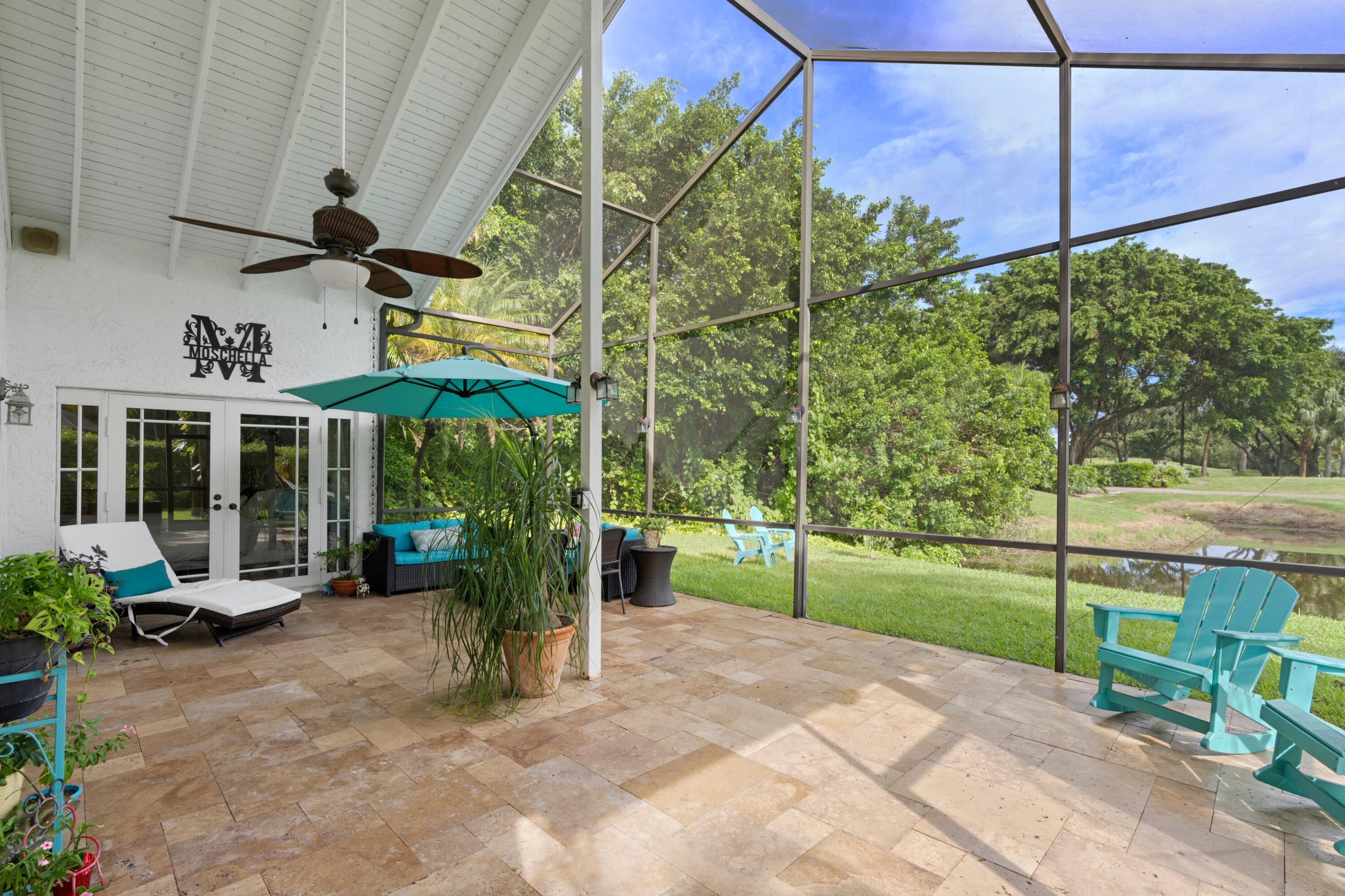 10238 Crosswind Road Boca Raton, FL 33498 - Photo 26 of 42 a view of a chairs and table in backyard of the house
