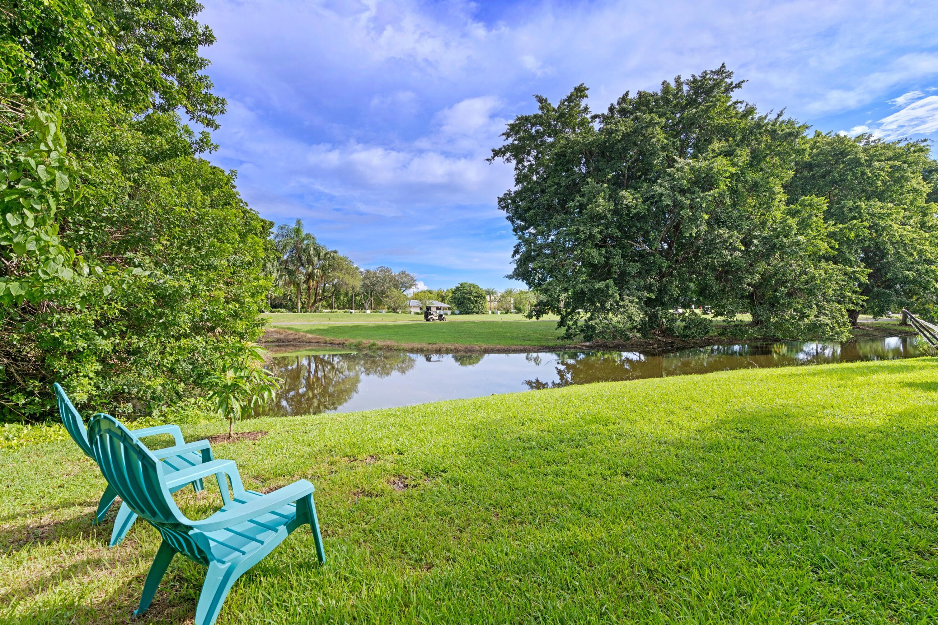 10238 Crosswind Road Boca Raton, FL 33498 - Photo 29 of 42 a view of yard with swimming pool and green space