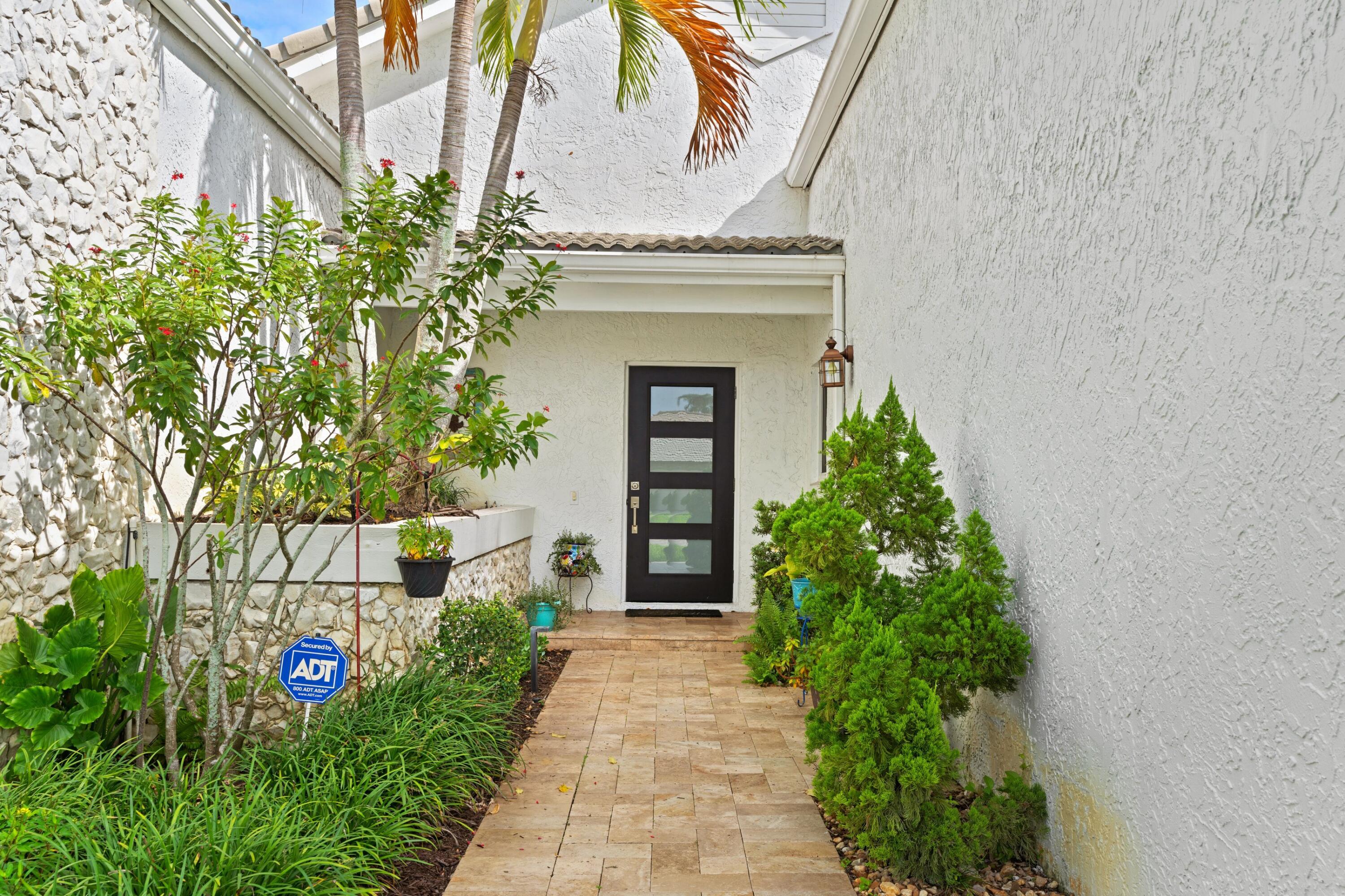 10238 Crosswind Road Boca Raton, FL 33498 - Photo 33 of 42 a front view of a house with garden