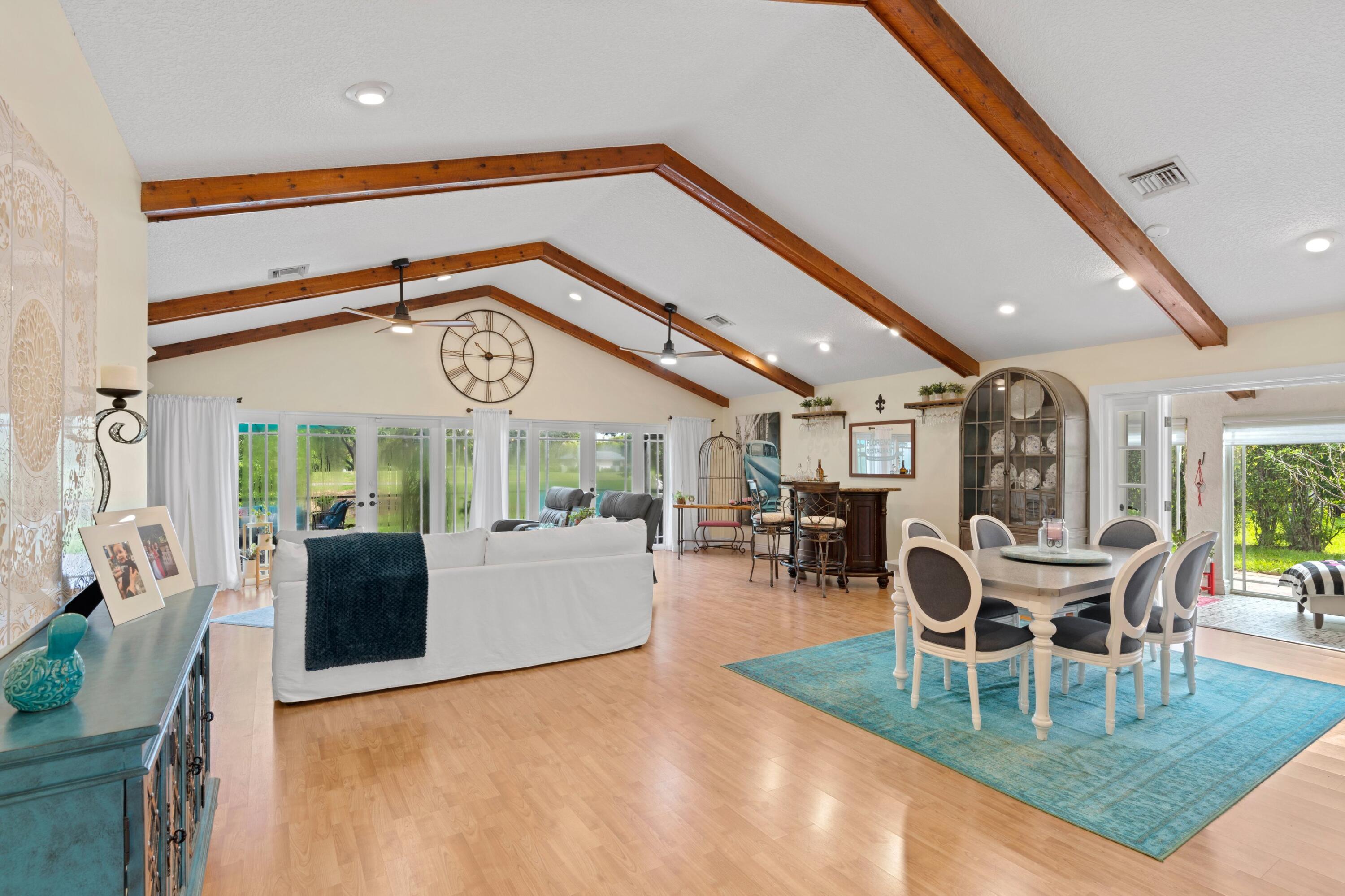 10238 Crosswind Road Boca Raton, FL 33498 - Photo 5 of 42 a dining room with furniture a fireplace and wooden floor