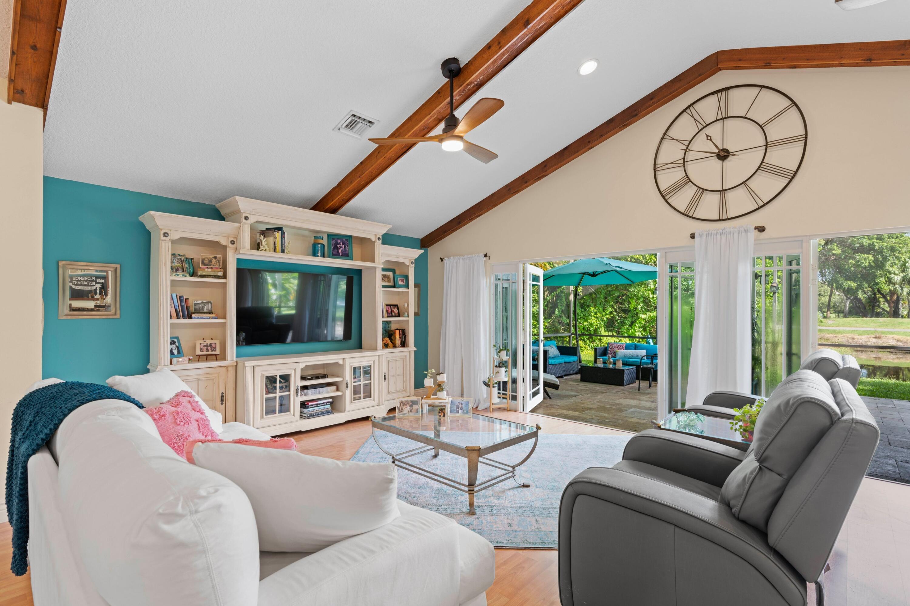 10238 Crosswind Road Boca Raton, FL 33498 - Photo 8 of 42 a living room with furniture a flat screen tv and a large window