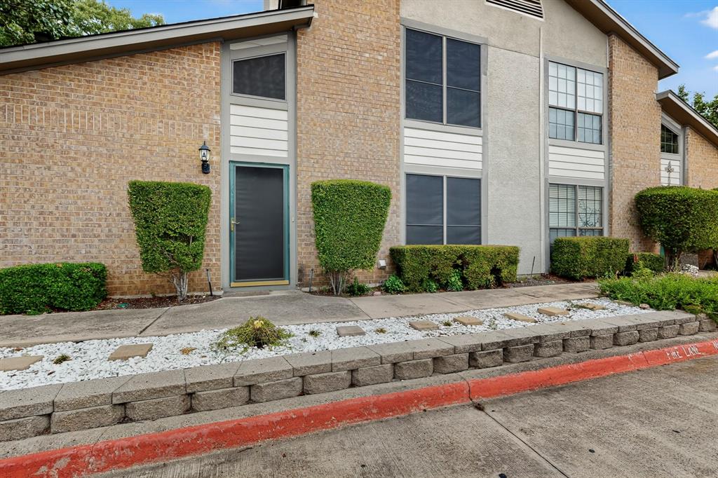 324 West Harwood Road, Unit A Hurst, TX 76054 - Photo 1 of 27 a front view of a house with garden