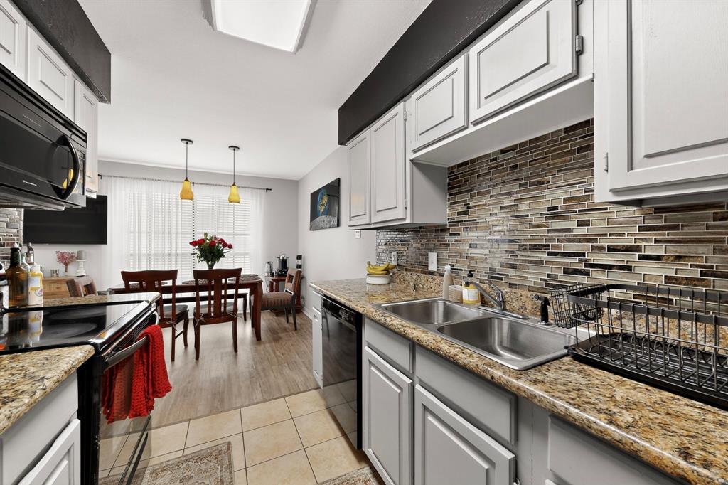 324 West Harwood Road, Unit A Hurst, TX 76054 - Photo 14 of 27 a kitchen with granite countertop a sink a stove and cabinets