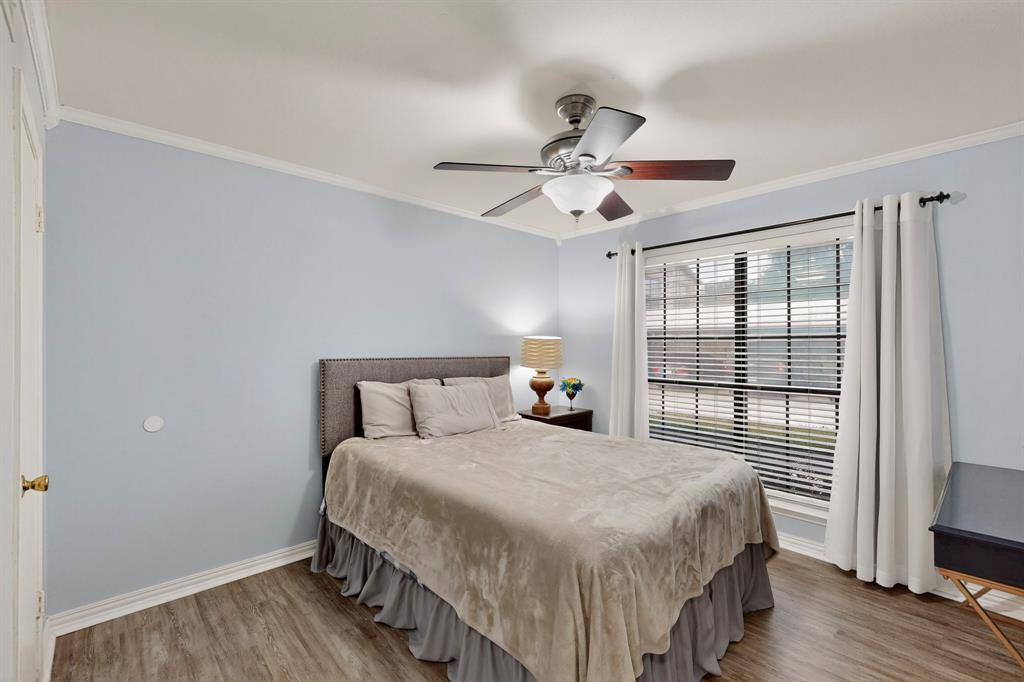 324 West Harwood Road, Unit A Hurst, TX 76054 - Photo 16 of 27 a bedroom with a large bed and a tv