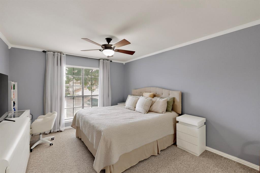 324 West Harwood Road, Unit A Hurst, TX 76054 - Photo 19 of 27 a bedroom with a bed and a chandelier