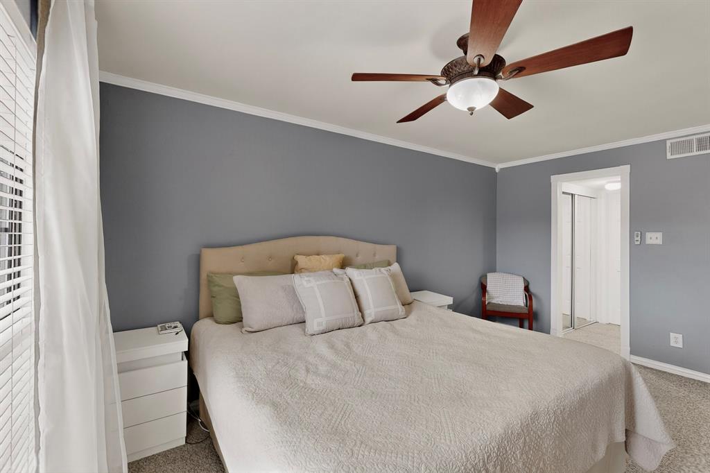 324 West Harwood Road, Unit A Hurst, TX 76054 - Photo 20 of 27 a bedroom with a bed and a large window