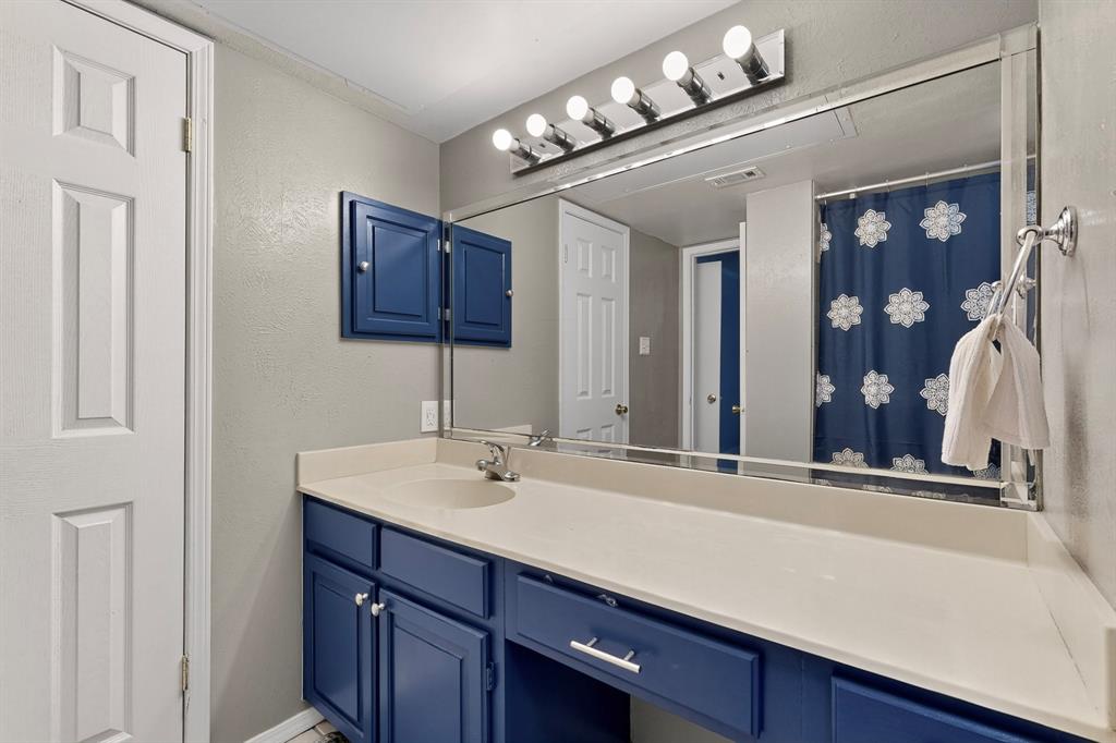 324 West Harwood Road, Unit A Hurst, TX 76054 - Photo 23 of 27 a bathroom with a sink and a mirror