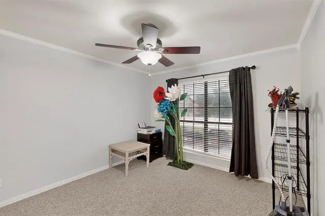 an empty room with closet and a chandelier fan