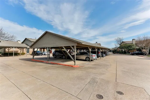 a view of house with outdoor space and parking