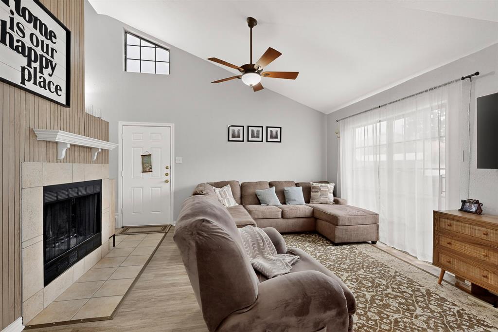 324 West Harwood Road, Unit A Hurst, TX 76054 - Photo 6 of 27 a living room with furniture a window and a fireplace