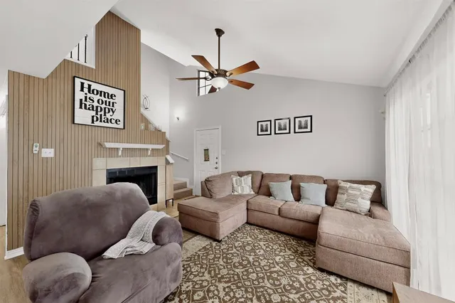 a living room with furniture fireplace and a window