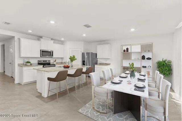 a living room with furniture a kitchen view and a refrigerator