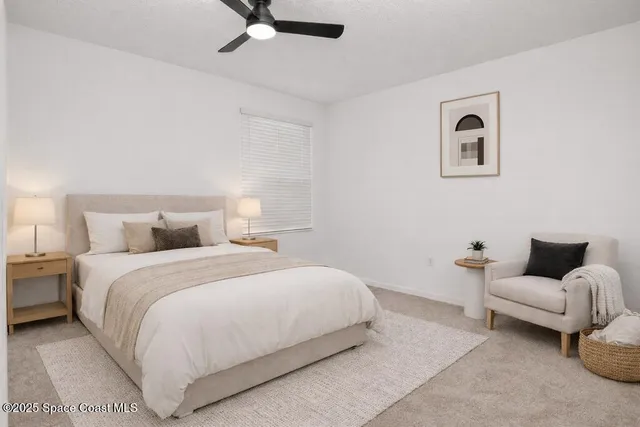 a bedroom with a bed and ceiling fan