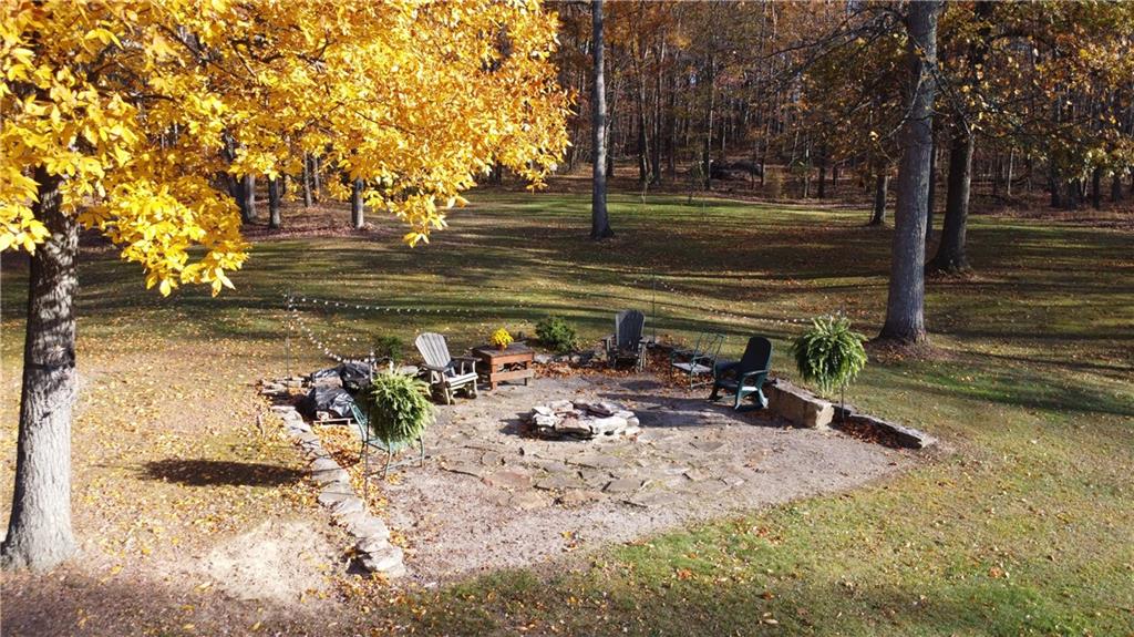 370 Braddock Road Farmington, PA 15437 - Photo 3 of 46 a view of a lake with a bench and trees around