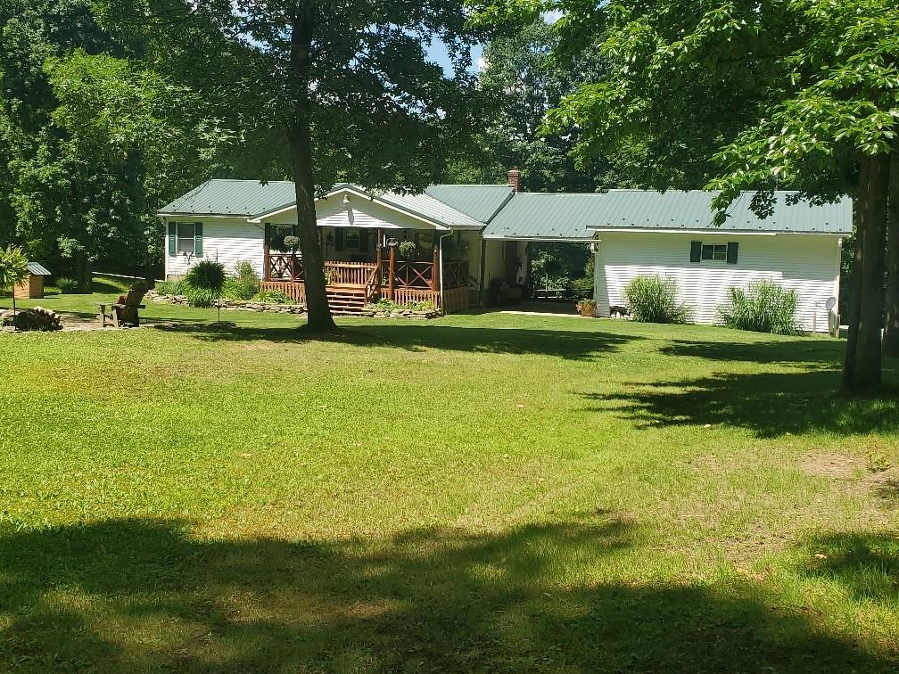 370 Braddock Road Farmington, PA 15437 - Photo 38 of 46 a front view of a house with yard and green space